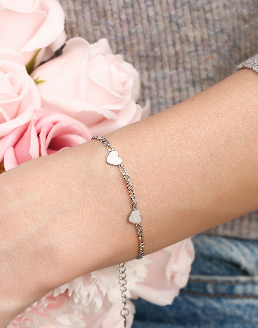 Schakelarmband drie hartjes zilverkleurig