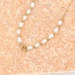 Paperclip ketting zoetwaterparels met hartjes goudkleurig