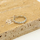 ring gevlochten zilverkleurig