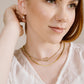 Ketting gedraaide schakel met steentjes en slotje goudkleurig