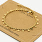 Twisted bracelet with gold-colored coins