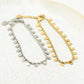 Twisted bracelet with gold-colored coins