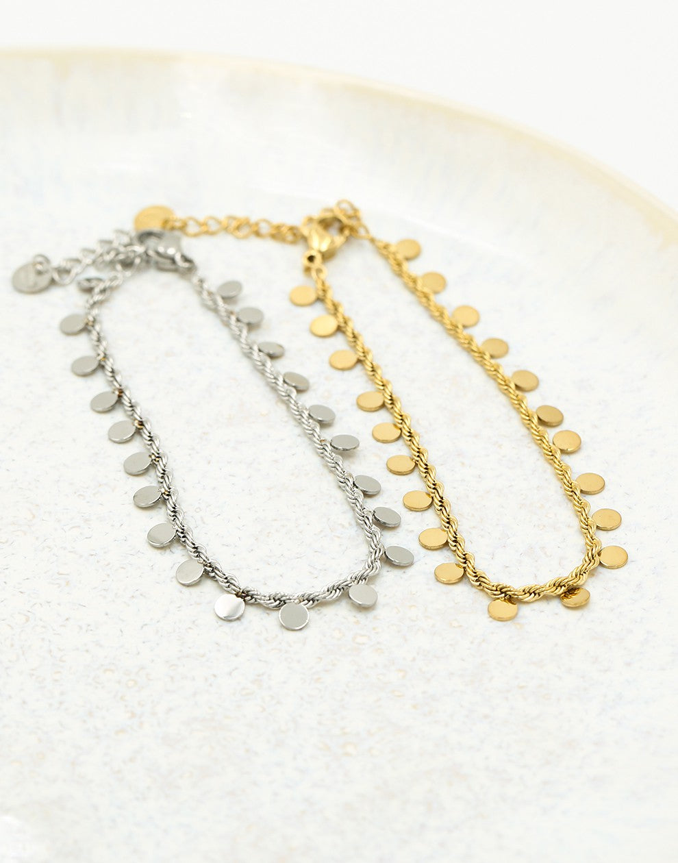 Twisted bracelet with gold-colored coins
