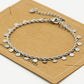 Twisted bracelet with silver-colored coins
