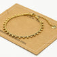 Gedraaide armband bolletjes goudkleurig