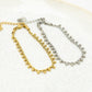 Gedraaide armband bolletjes goudkleurig