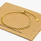 Schakelarmband bolletjes goudkleurig
