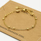 Armband dubbel bolletjes goudkleurig