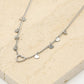 Fijne ketting open hartje met vallende hartjes zilverkleurig