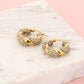 Twisted hoop earrings with rhinestones in gold color
