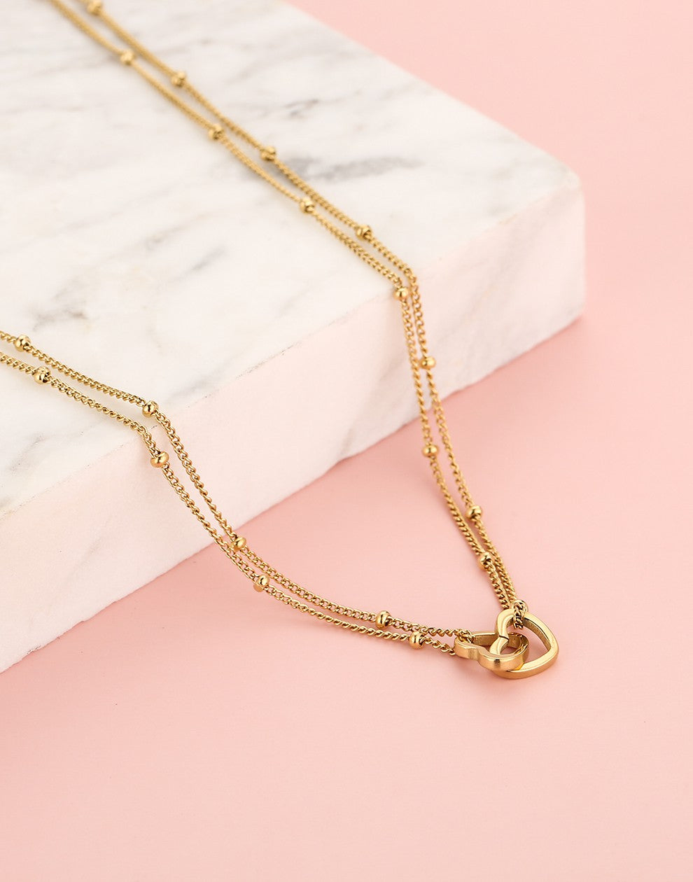 ketting bolletjes met dubbele hartjes goudkleurig