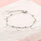 Silver-colored beaded bracelet with coins