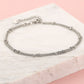Ankle bracelet with double silver-colored beads
