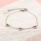 armband drie hartjes rood zilverkleurig
