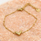 Armband V bolletjes goudkleurig
