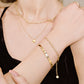 Gedraaide armband bolletjes goudkleurig