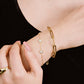 Schakelarmband gevlochten goudkleurig