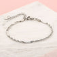 Gedraaide schakelarmband zilverkleurig