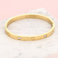 Bangle steentjes en hartjes goudkleurig