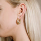 Twisted hoop earrings with rhinestones in gold color