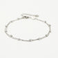 Ankle bracelet with double silver-colored beads and chains