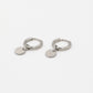 silver-colored coin earrings