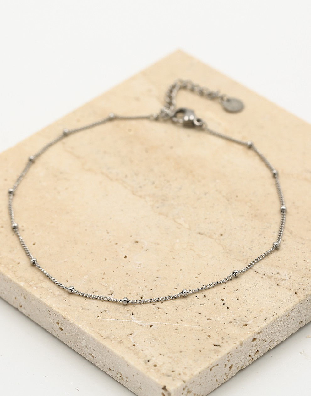 Ankle bracelet with silver-colored beads and links