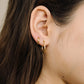gold-colored twisted hoop earrings