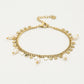Armband met goudkleurigen muntjes en parels