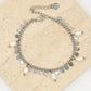 Armband met zilverkleurigen muntjes en parels