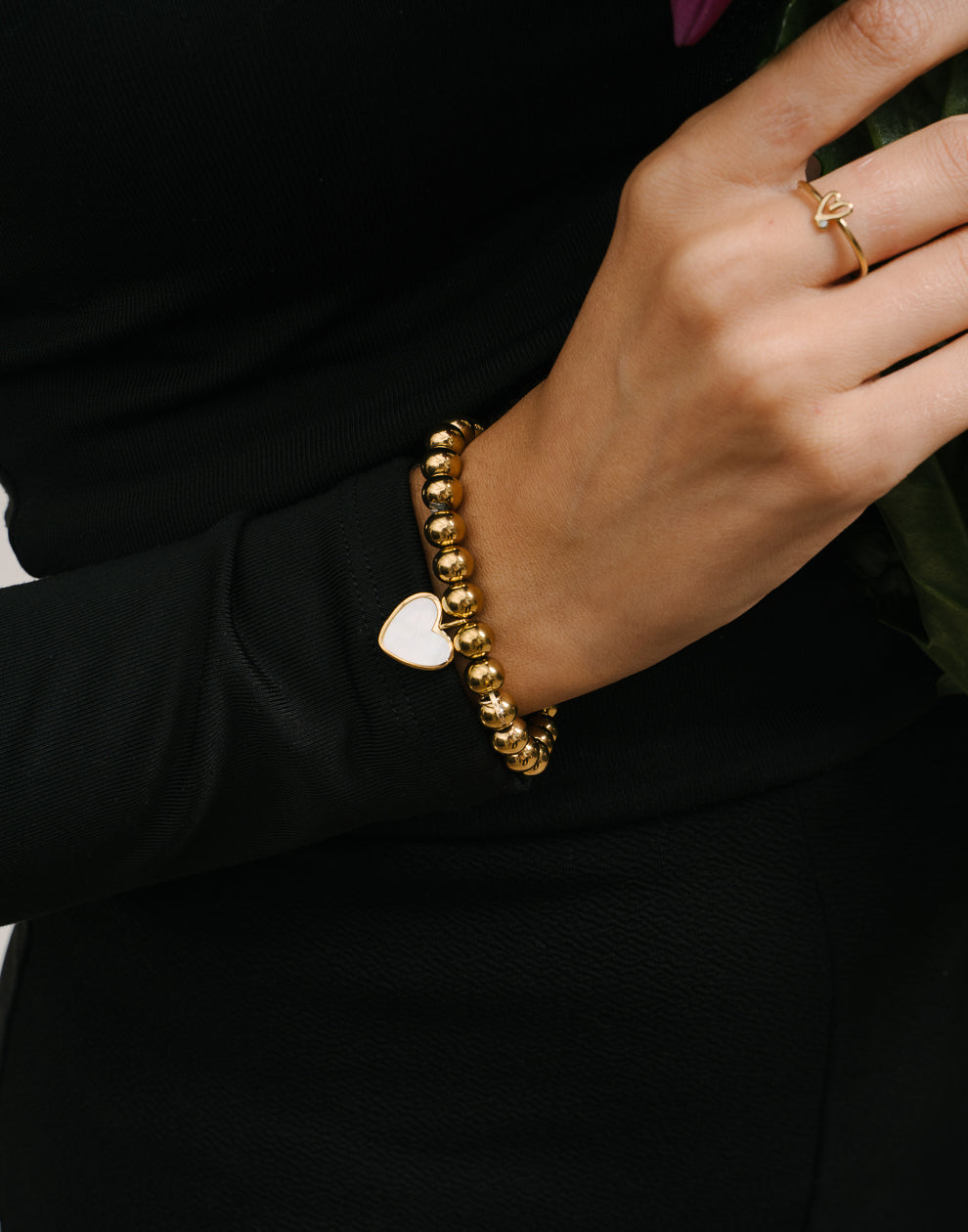 Stretch armband gouden bolletjes met hartjes goudkleurig