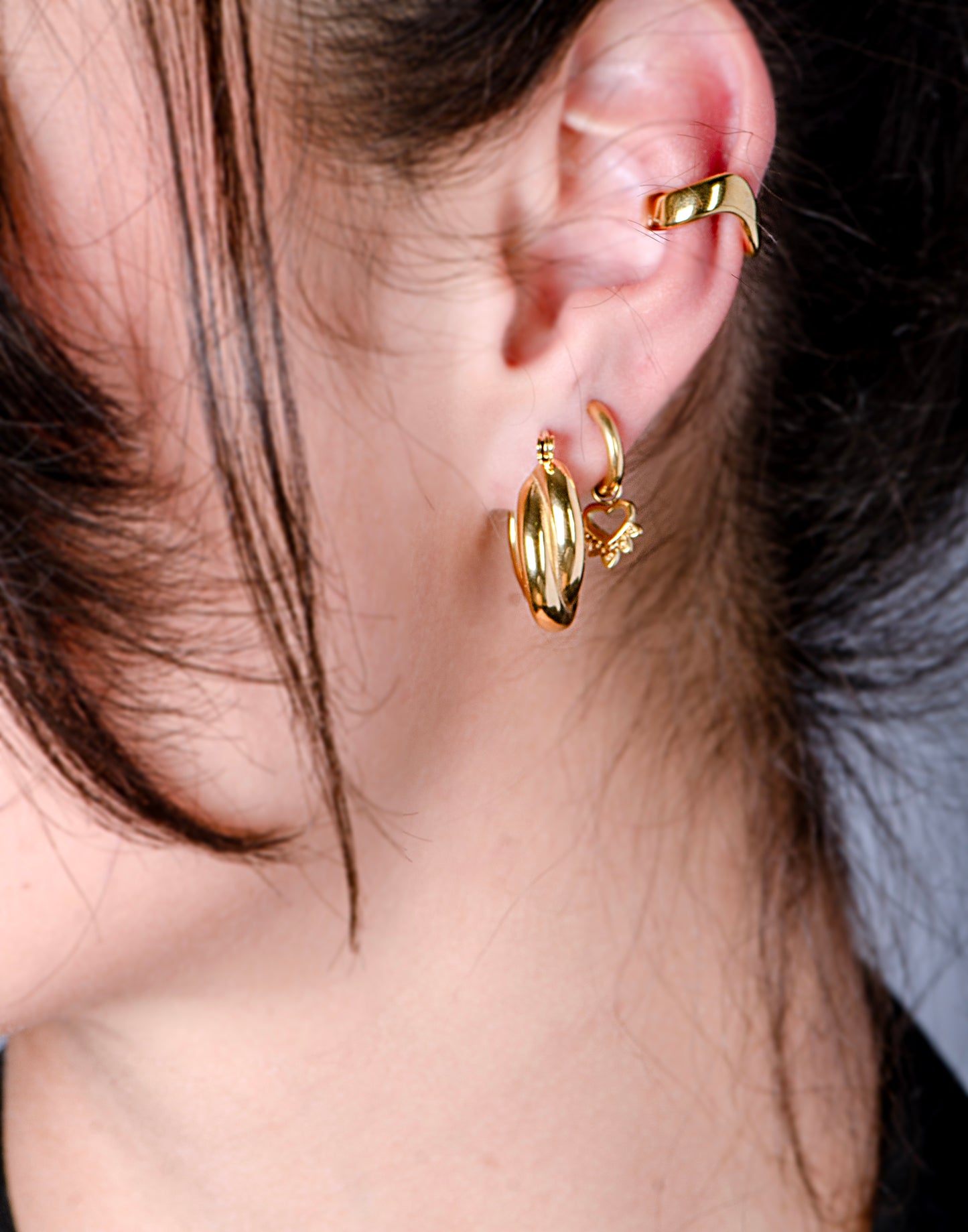Gold-colored hoop earrings with hanging heart