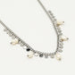Schakelketting met zilverkleurigen muntjes en parels