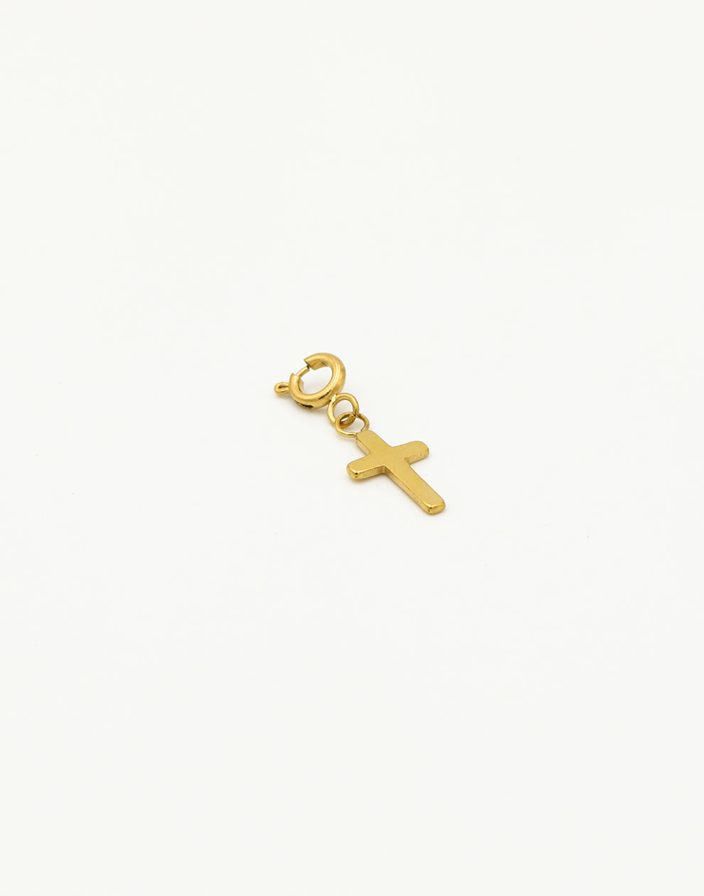 Loose gold-colored cross charm