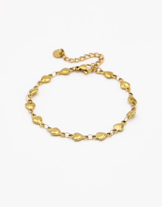 Schakelarmband kleine hartjes goudkleurig