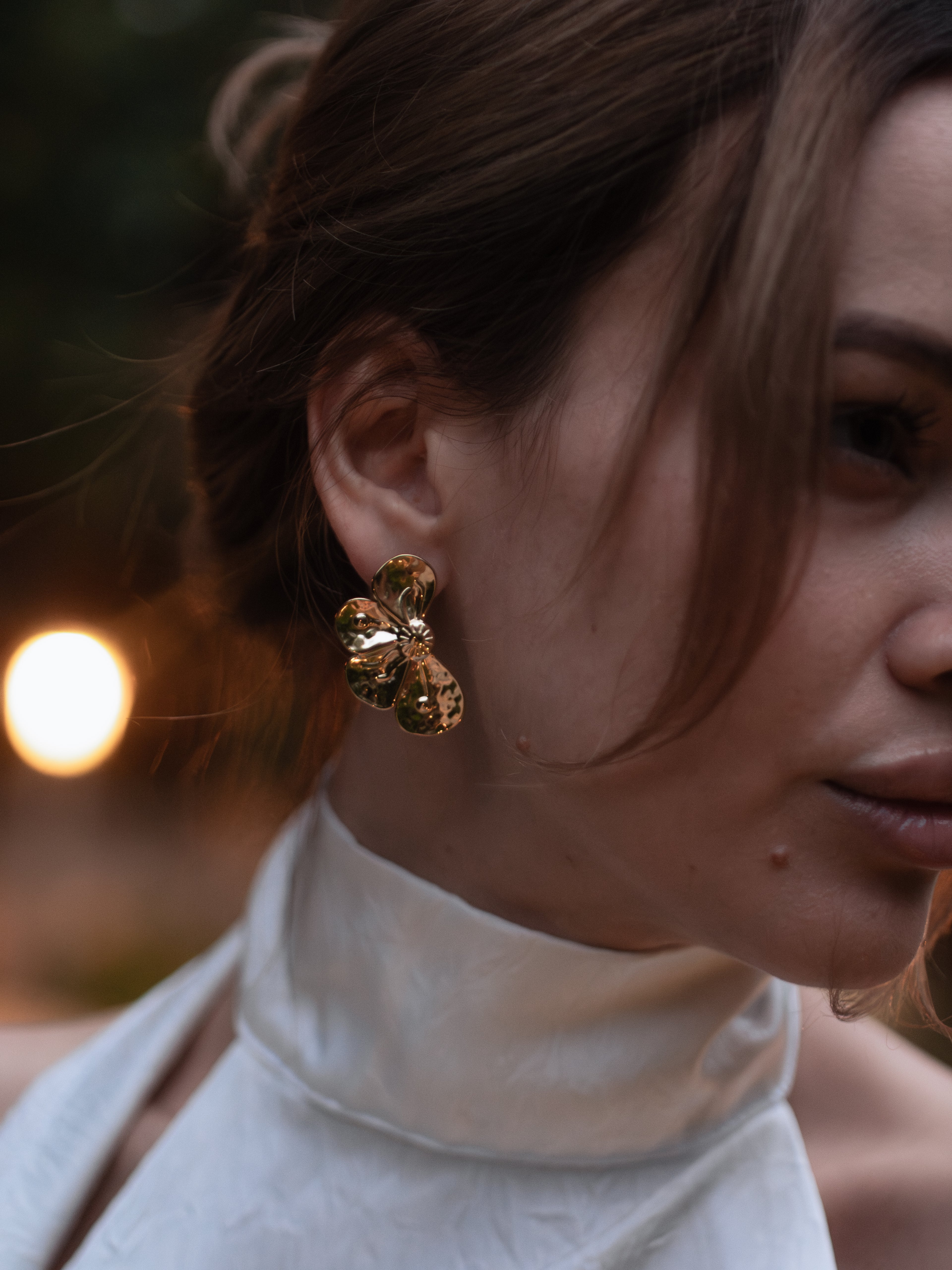 gold-colored flower stud earrings